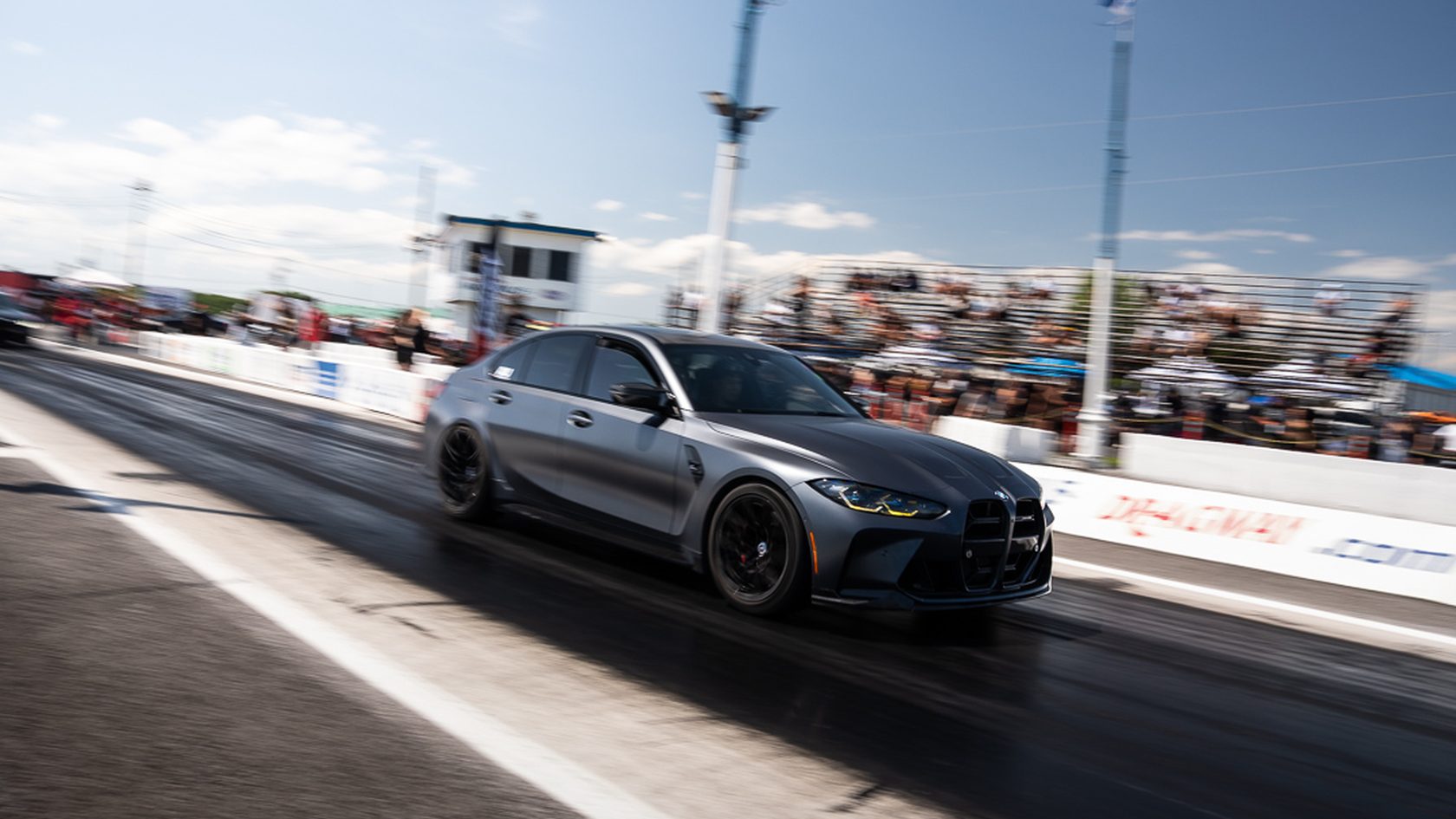 A grey BMW M4 mid-run
