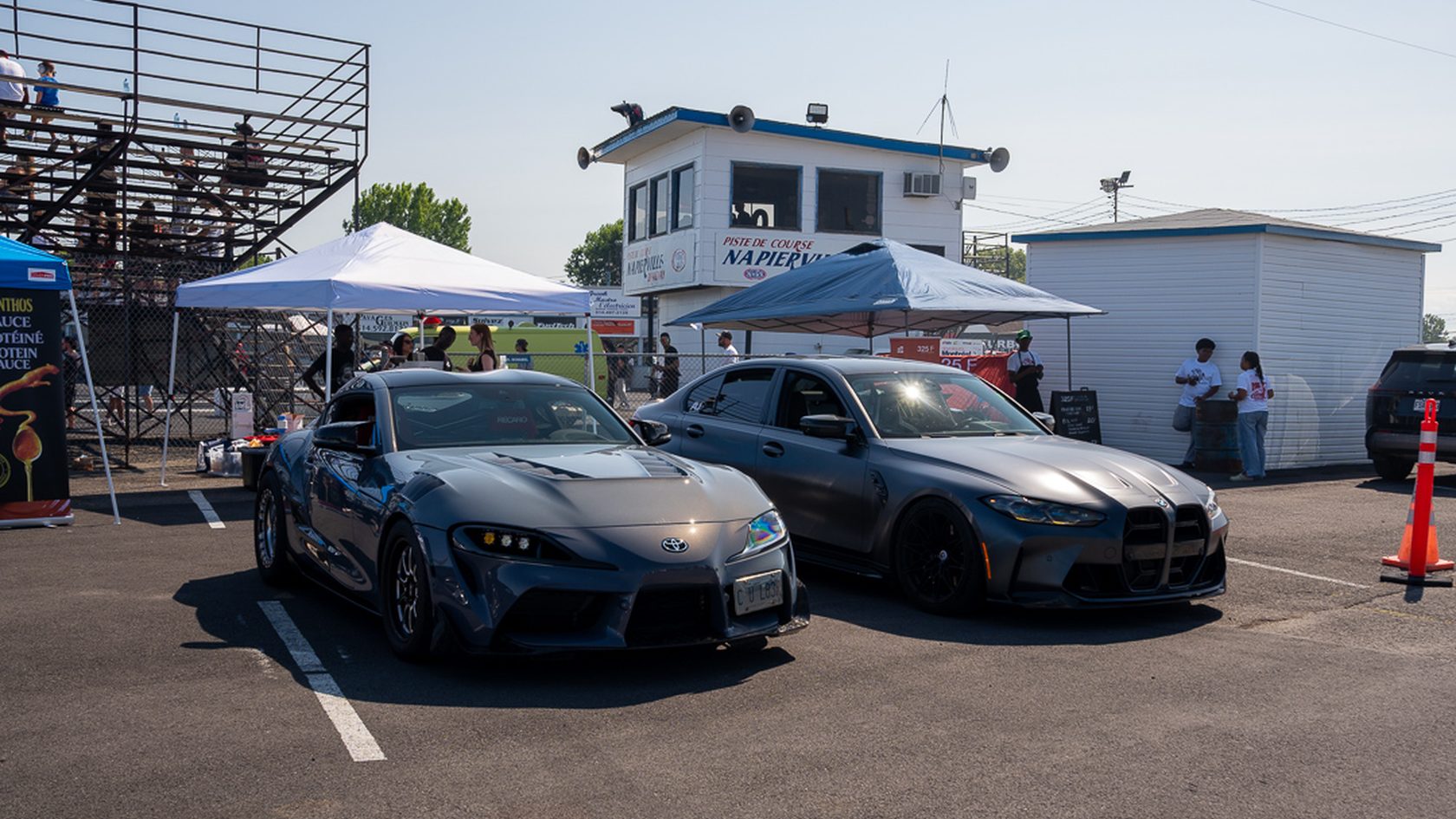 A Supra and M4 rolling through the pits